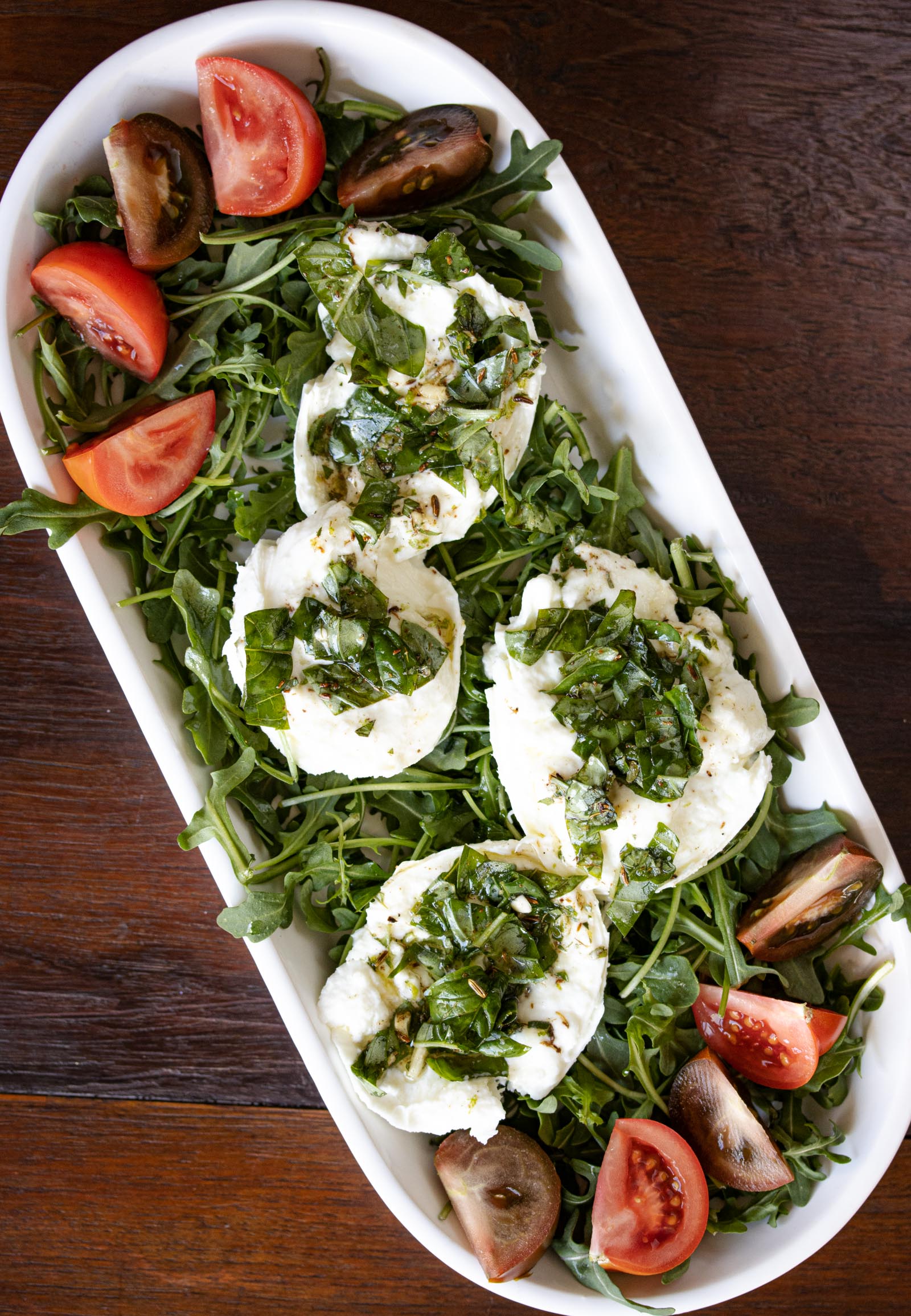 Buffalo mozzarella marinated, with tomatoes and arugula Buffalo mozzarella marinated, with tomatoes and arugula