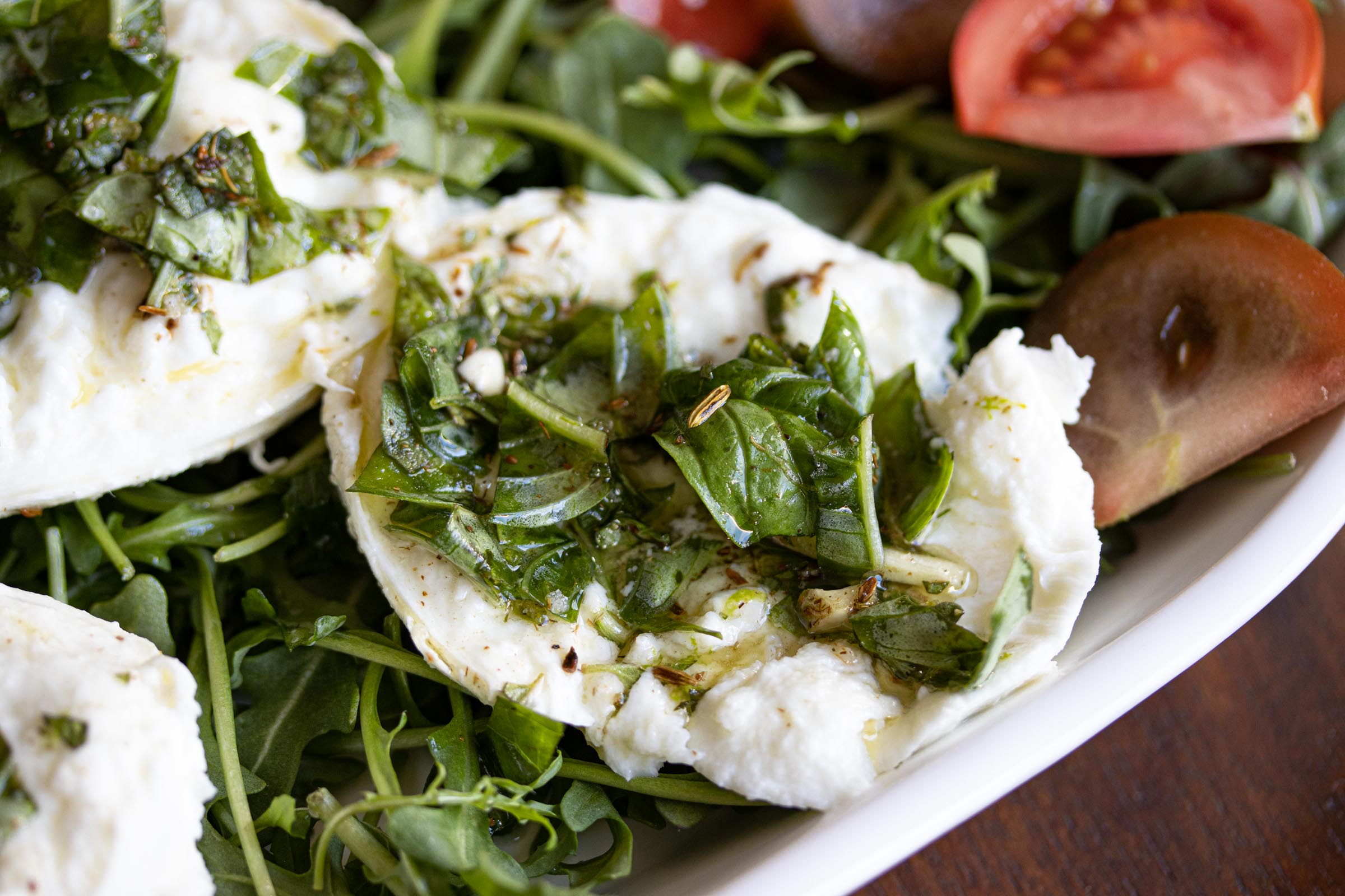 Buffalo mozzarella marinated, with tomatoes and arugula Buffalo mozzarella marinated, with tomatoes and arugula